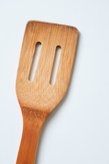Close-up of bamboo kitchen spatula isolated on white background