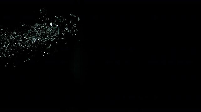 Super Slow Motion Shot of Real Side-Flying Glass Shards Isolated on Black at 1000 fps.