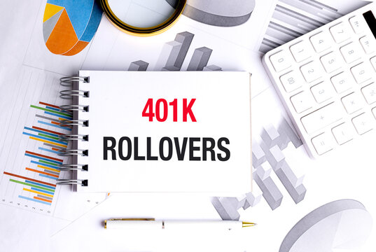 401k rollovers text on notepad with financial charts, calculator and pen on white office desk