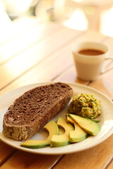Artisan sourdough bread loaf sliced on parchment paper Wooden table background