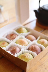 Cute Chinese Pastry or moon cake stuffed with salted egg yolk on wood plate