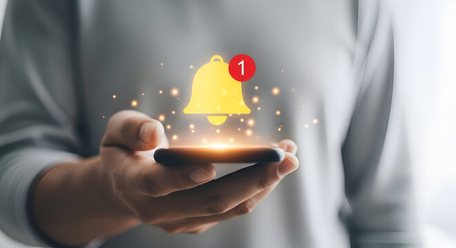 Man holding smartphone with notification bell icon, new message, reminder, social media concept