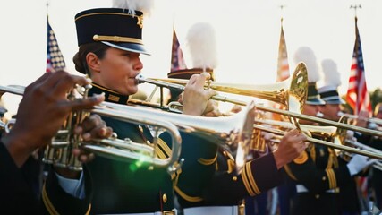 Diverse military brass band performs patriotic music at a public event. Veterans day commemoration with marching band in uniform.