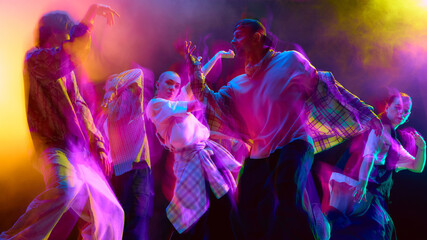 Group of young dancers expressing rhythm with motion blur. Concept of performing arts, modern dance...