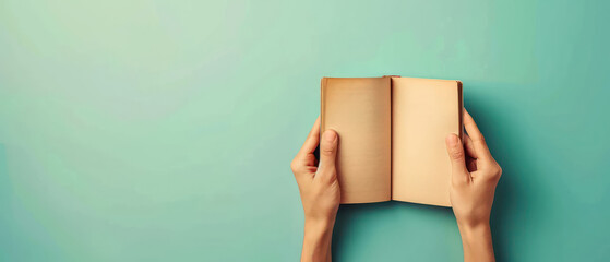 Person holding open blank notebook with both hands pastel background minimalistic and calm scene