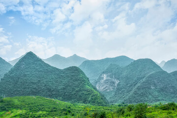 Green Mountain Range Under Blue Sky with White Clouds Landscape