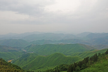 Fototapeta premium Aerial View of Moganshan Scenic Area Surrounded by Green Mountains
