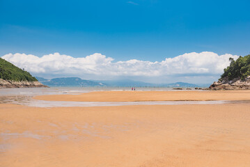 Golden Sand Beach with Turquoise Sea and Blue Sky White Clouds Coastal View