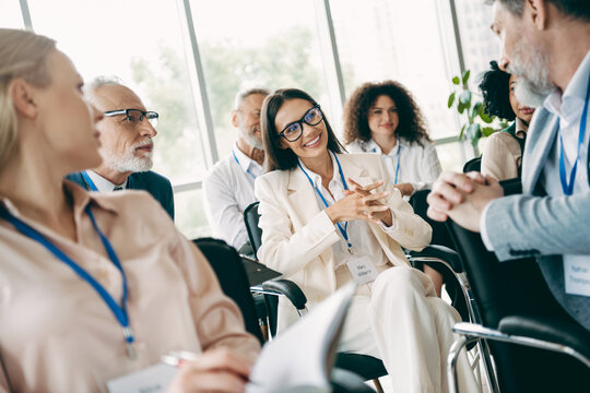 Fototapeta Diverse Team Engaging in Collaborative Discussion During a Corporate Training Session in a Contemporary Office Setting