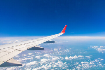 Airplane Wing Flying Through Blue Sky and White Clouds Travel View