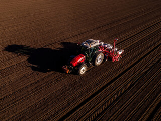 Tractor sowing seeds in a fertile agricultural field