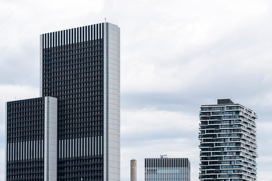 Frankfurt modern architecture skyline with glass business tower and urban finance district under cloudy daylight showing cityscape reflections