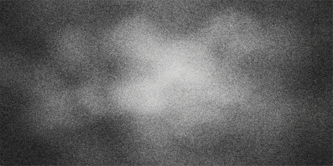 Abstract textured background with a bright center and dark grainy edges in grayscale