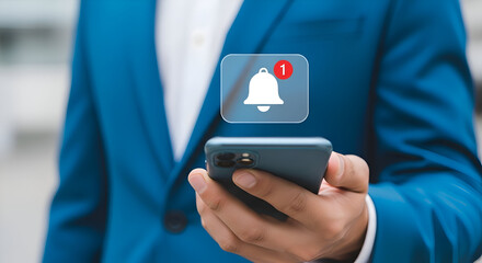 Notification bell icon on mobile phone screen with a man in a suit in the background