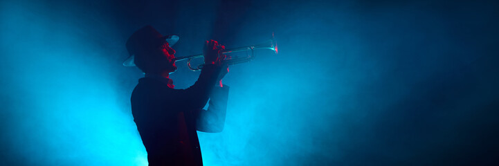 Saxophone player silhouette in yellow light with smoky stage background. Concept of music gear promotion, music schools and courses illustration, and art design use. Banner