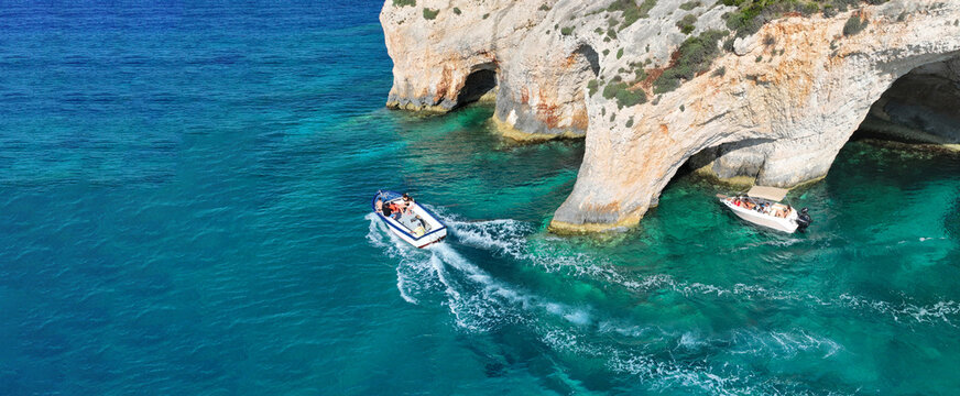 Aerial drone ultra wide panoramic photo of scenic paradise complex of blue caves in Northern part of Zakinthos island a tourist attraction visited by small boats and cruises, Ionian, Greece