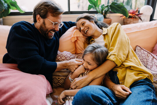 Family laughter on the couch together