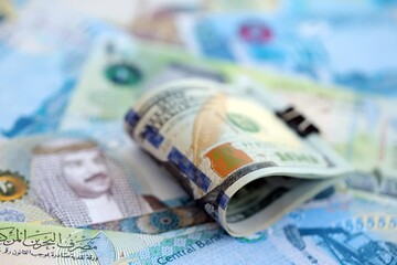 Bahraini dinar currency money bills and bunch of us dollar banknotes close up. The concept of economics and currency exchange