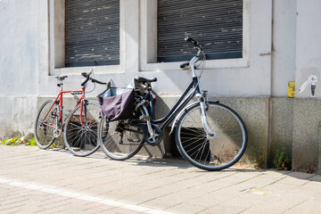 Bicycle parked on the cobbled street on the city street.