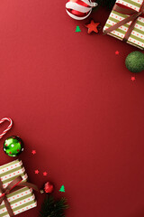 Christmas flat lay with polka dot gifts, baubles, candy cane, pine branches, and festive confetti on red background. Perfect for seasonal greeting, card, or holiday promo.
