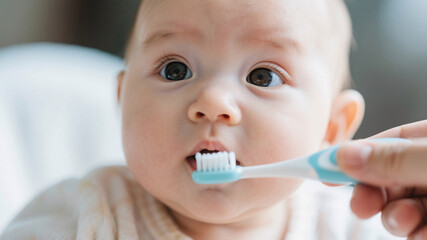 Intimate close-up of infant’s fascinated expression seeing toothbrush for the first time, reflected light in eyes and shallow depth evoking tenderness.
