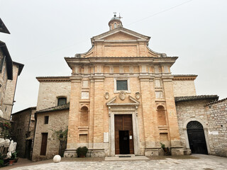 Fototapeta premium Assisi Chiesa Nuova church facade in Italy with historic architecture and visitors outside the entrance