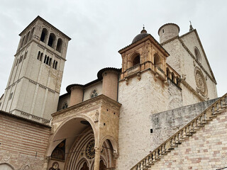Assisi Basilica with Stone Staircase and Crowds in Historic Italy