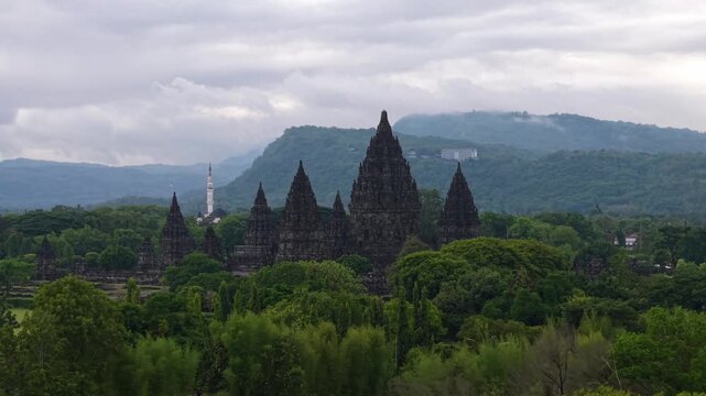 Aerial View of the Prambanan Temple compound against a backdrop of lush greenery and misty mountains, Yogyakarta, Daerah Istimewa Yogyakarta, Indonesia.
