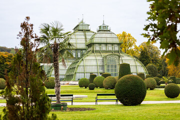 Selective focus view of the Palmenhaus Schönbrunn, a large 1882 greenhouse in the palace’s park seen in the fall, Vienna, Austria