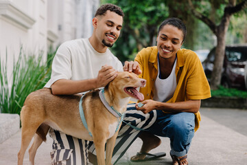 Couple bonding with their dog outdoors on a sunny day