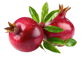 Two whole ripe pomegranates with green leaves