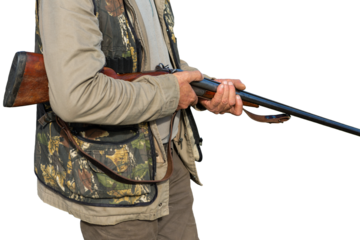 Midsection of man hunter stands with a gun in his hands.