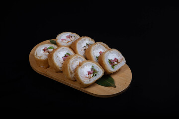 Delicious Japanese sushi set with nigiri, maki rolls, and soy sauce served on a wooden board. Traditional Asian cuisine concept.