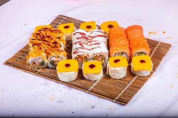 Delicious Japanese sushi set with nigiri, maki rolls, and soy sauce served on a wooden board. Traditional Asian cuisine concept. © Ulgen