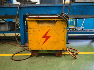 Industrial Electrical Power Box with Warning Sign in Factory Setting