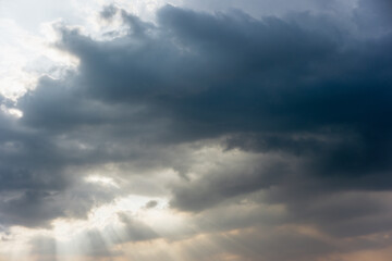 Obraz premium Ray of Light Shining Through Heavy Grey Clouds on an Overcast Day