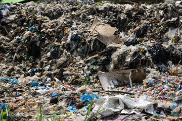 A Detailed Close Up of Mixed Garbage and Plastic Waste Piled Up at a Dumpsite