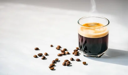 Fotobehang Café Hot espresso coffee steam rises from hot coffee in coffee glass and bean isolated on white background in Morning sunlight  © NARONG