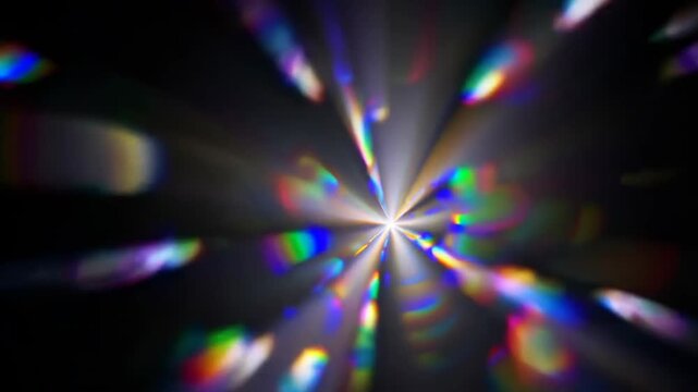 Abstract rainbow lens flare with soft radial bloom and natural light scatter on black background.