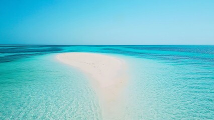 Obraz premium Aerial view of a secluded white sandbar surrounded by crystal-clear turquoise ocean water under a perfect blue sky.