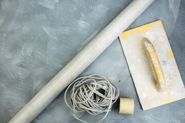 Building tools on the gray concrete background. Copy space. Top view..