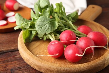 Fresh ripe radishes on wooden table, closeup