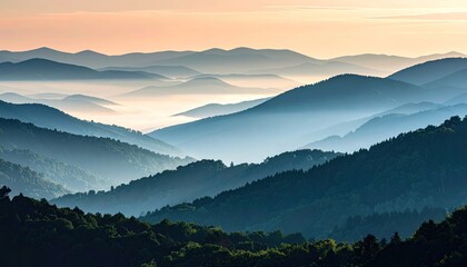 Layered Blue Green Mountain Ranges Fade Into Distant Hazy Mist Under A Soft Pink Sunrise Sky With Silhouetted Evergreen Trees In The Foreground