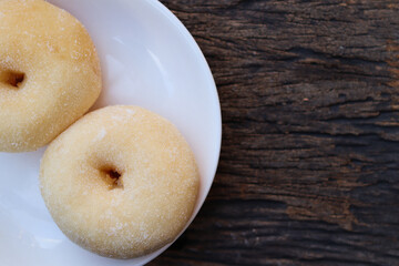 Sugar donuts on white plate