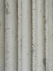 Fototapeta premium Fluted stone column with weathered surface classical architecture and structure. Copyspace.
