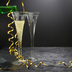 New Year concept, with bright light and champagne glass, abstract bokeh background