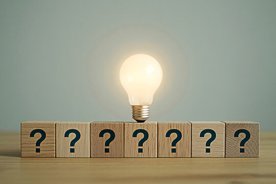 Lightbulb idea concept with question marks on blocks creative thinking problem solving innovation solution 100