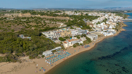 Aerial view of the beach and town of Selinunte, a hamlet of Castelvetrano, located in the province of Trapani, Sicily, Italy. In background is the archaeological park of the ancient Greek acropolis.
