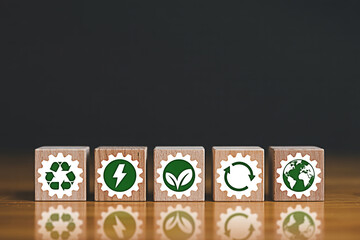 Eco friendly sustainable development concept wooden blocks with green energy and recycle icons