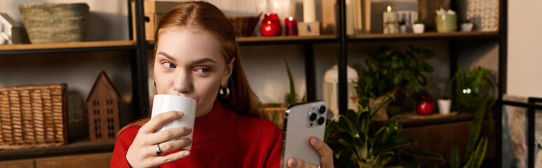 Cozy moments at home with a warm drink and a smartphone in hand